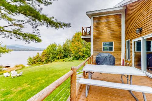 a deck with a table and chairs on a house at East Cove in Greenville