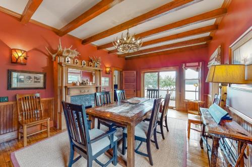 a dining room with red walls and a wooden table and chairs at East Cove in Greenville