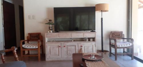 un soggiorno con una TV sopra un mobile di Ñanderoga a Lavalle