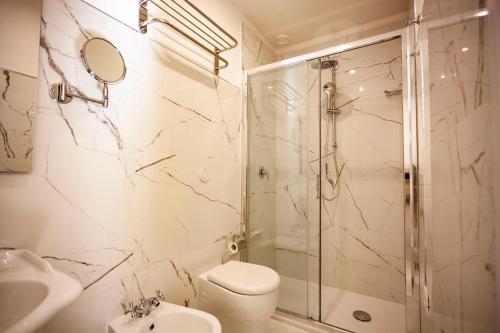 a bathroom with a shower and a toilet and a sink at Villa Royal B&B in Florence
