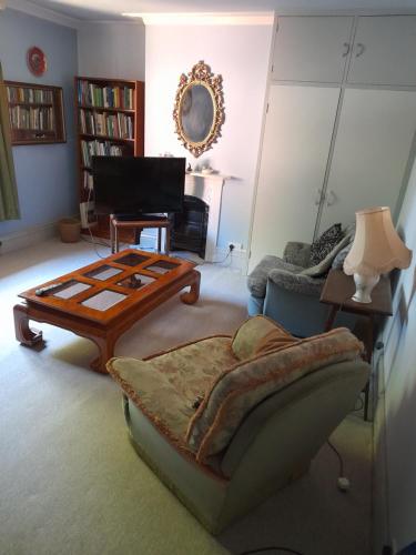 a living room with a coffee table and a couch at Fern Cottage in Scalby