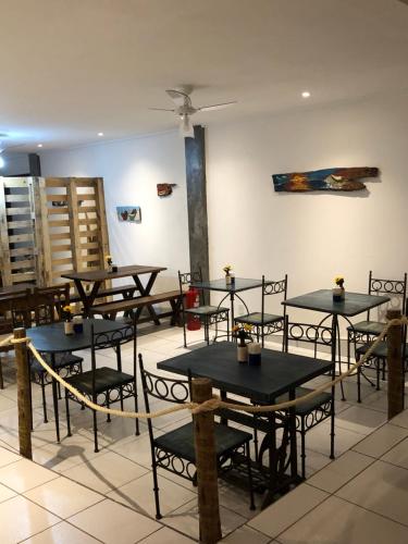 a group of tables and chairs in a room at Pousada Escotilha in Arraial do Cabo