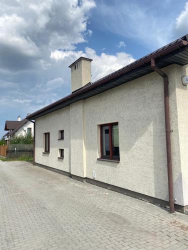 a white building with a tower on top of it at Dom na wyłączność #Beskidzka FV PARKING IMPREZY dozwolone in Rzeszów