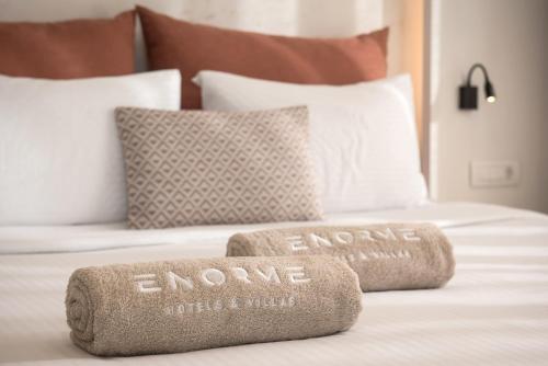 a bed with two towels that say endgame on it at Enorme Teatro Beach in Amoudara Herakliou