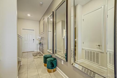 a bathroom with two mirrors and two green trash cans at Storey Lake Resort, Private Pool, Near Famous Attractions!! in Kissimmee