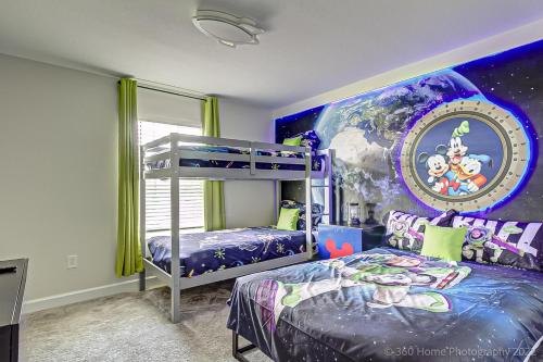 a bedroom with two bunk beds and a mural at Storey Lake Resort, Private Pool, Near Famous Attractions!! in Kissimmee