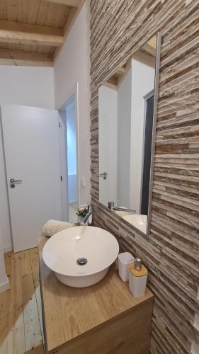 a bathroom with a white sink and a mirror at O Cantinho da Penetra AL in Santar