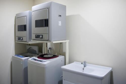 a bathroom with two computer monitors on top of a sink at Grace Hotel in Taipei