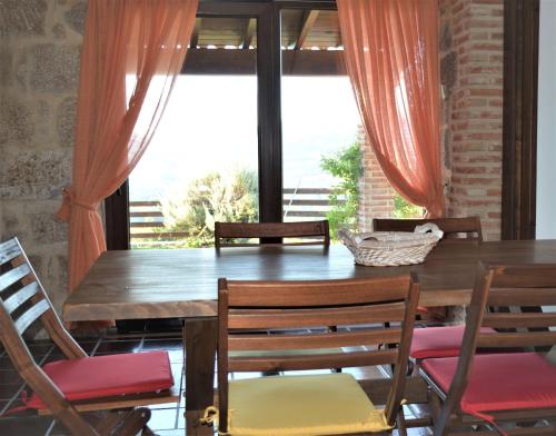 a dining room with a table and chairs and a window at Airiños de Mondariz in Mondariz