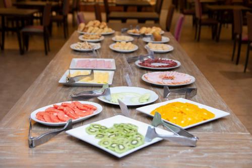 a long table filled with different types of food at Hotel Las Dunas in El Calafate