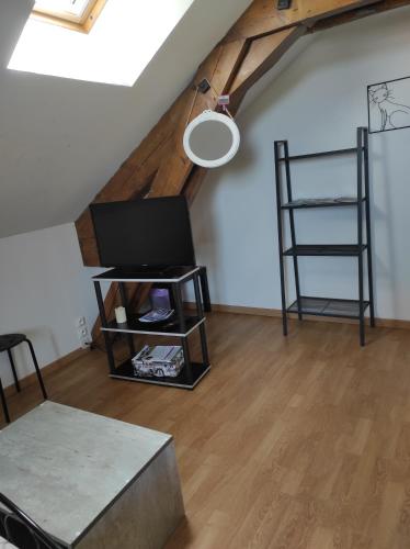 a living room with a tv and a table at La Cabanette in Saint-Agrève