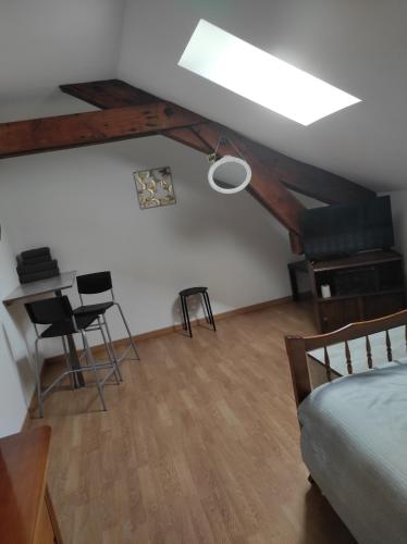 a bedroom with a bed and a table and chairs at La Cabanette in Saint-Agrève