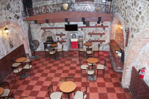 a room with tables and chairs in a building at Hotel Hacienda Vista Hermosa in Tequesquitengo