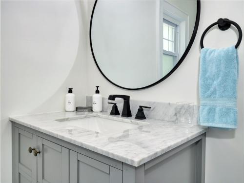 a bathroom with a sink and a mirror at Deck View of Hudson River & Mt Beacon / Boho Suite in Newburgh