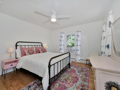 a white bedroom with a bed and a ceiling fan at Deck View of Hudson River & Mt Beacon / Boho Suite in Newburgh