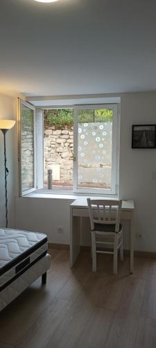 a bedroom with a desk and a window and a chair at Studio meublé à Bougival in Bougival