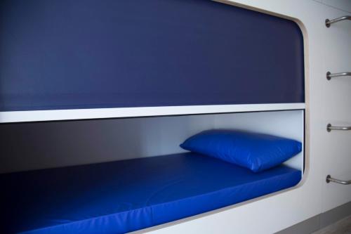 a blue pillow is sitting on a blue bench at Hostel Cross in Lugo