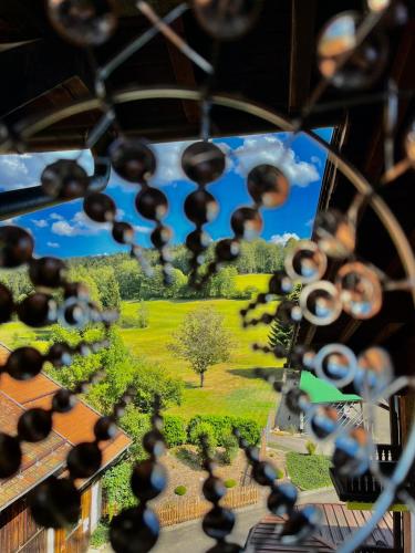 a view of a garden from a bottle of wine at Landhotel GrünWies -Bonsai-Wellness Garni in Lohberg