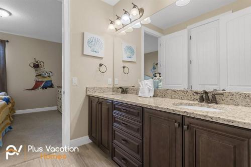 a bathroom with a sink and a large mirror at 520-Villa by Disney 8 Bedrooms wPool & SPA in Orlando