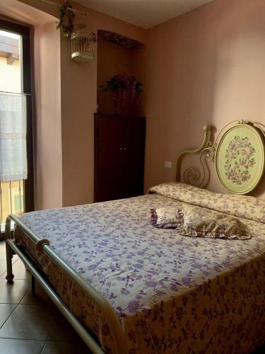 um quarto com uma cama grande e uma colcha roxa em Da Giusy em Stresa