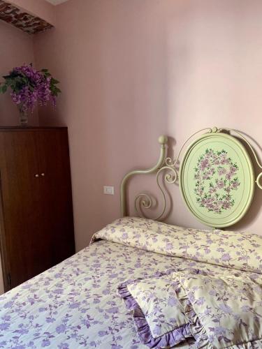 a bedroom with a bed with a green head board at Da Giusy in Stresa