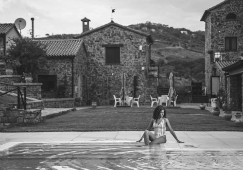 a young girl sitting in a pool of water at Le Querce Farmhouse in Agropoli