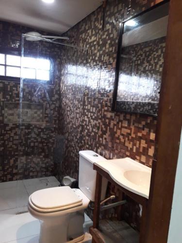 een badkamer met toilet en wastafel bij cantinho bom in Ubatuba