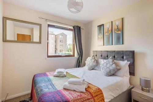 a bedroom with a bed with towels on it at The SUMMIT Apartment - Aberdeen City Centre - Perfect for Long and short Stay in Aberdeen