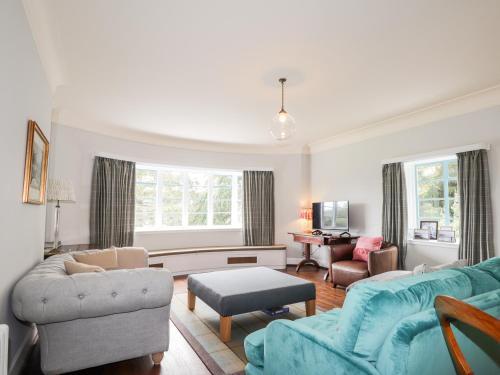 a living room with a couch and chairs and a table at Inverewe - House Apartment in Achnasheen