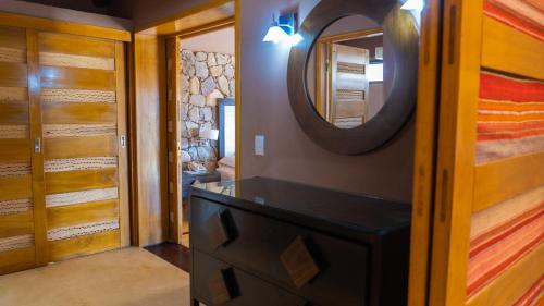 a bathroom with a dresser and a mirror on a wall at Las Marías Hotel Boutique in Tilcara