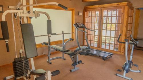 a gym with two exercise bikes and a treadmill at Las Marías Hotel Boutique in Tilcara