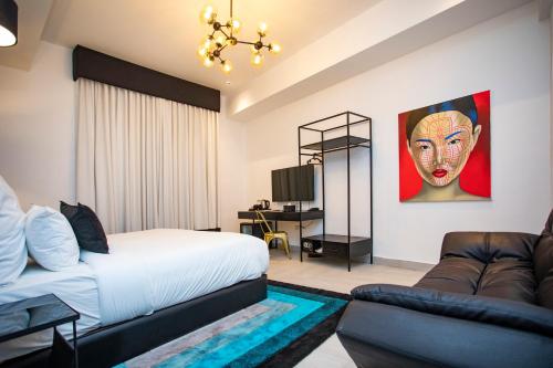 a bedroom with a bed and a couch at Hotel Philosophy in Amman