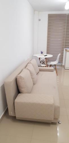 a white couch in a living room with a table at Apartament Vila Brana Sibiu Selimbar str Nicolae Brana Nr 63 Ap 4 in Şelimbăr