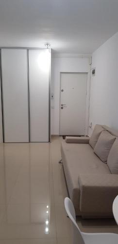 a white room with a bed and a sliding glass door at Apartament Vila Brana Sibiu Selimbar str Nicolae Brana Nr 63 Ap 4 in Şelimbăr