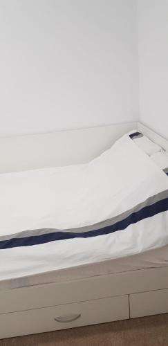 a bed in a room with a white mattress at Apartament Vila Brana Sibiu Selimbar str Nicolae Brana Nr 63 Ap 4 in Şelimbăr