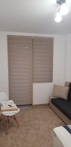 a room with a bed and a table and a couch at Apartament Vila Brana Sibiu Selimbar str Nicolae Brana Nr 63 Ap 4 in Şelimbăr