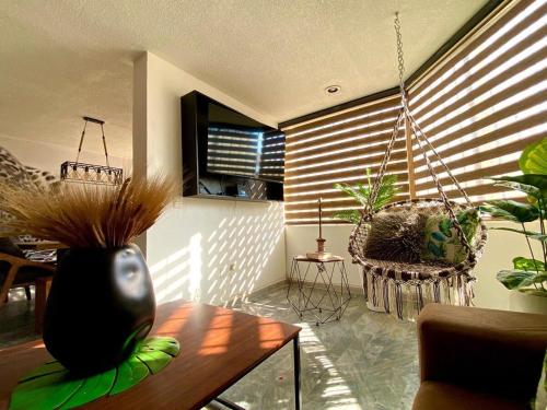 a living room with a vase on a table at Planta Baja Enorme, Jardín, Parking, Hasta 11 Pax in Guadalajara