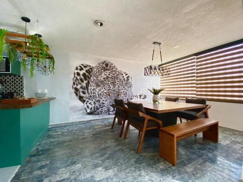 a dining room with a table and some animals on the wall at Planta Baja Enorme, Jardín, Parking, Hasta 11 Pax in Guadalajara