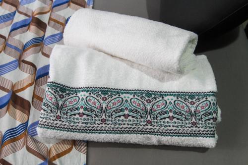 a pile of towels sitting on top of a table at Studio no Largo da Carioca - Rio de Janeiro in Rio de Janeiro
