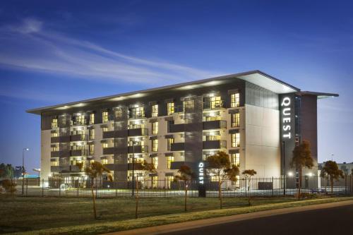 a large building with lights in front of it at Quest Melbourne Airport in Melbourne