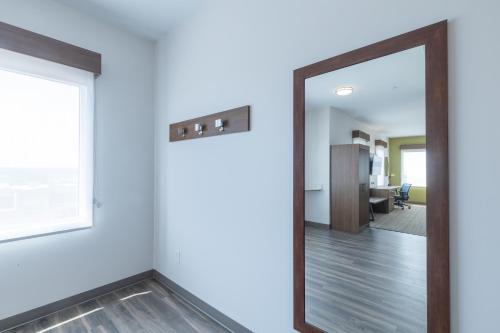 a mirror in a room with a hallway at Holiday Inn Express & Suites Columbia Downtown The Vista by IHG in Columbia