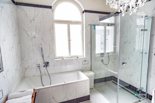 a white bathroom with a tub and a shower at Unique location with garden and terrace Old Town in Prague