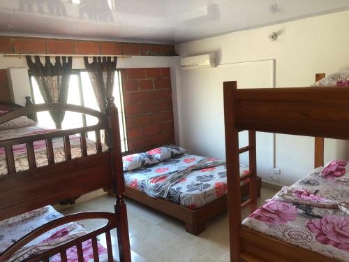 a room with three bunk beds and a window at CASA EN DORADAL in Puerto Triunfo