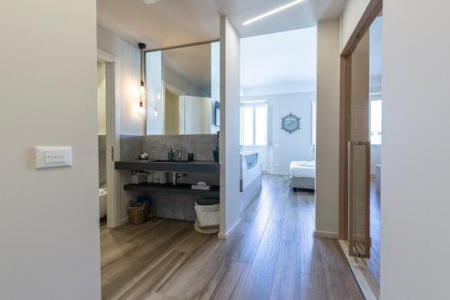 a bathroom with a toilet and a mirror in a room at La Romantica camere e wellness in Senigallia