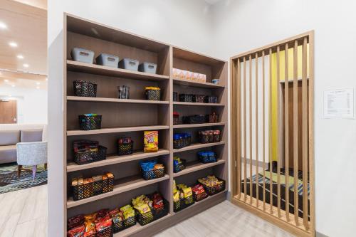 a walk in pantry with shelves filled with food at Holiday Inn Express & Suites Columbia Downtown The Vista by IHG in Columbia