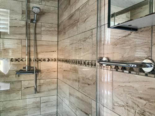 a bathroom with a shower with a glass door at Corbridge Road in Reading
