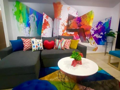 a living room with a couch and a table at 2 BEDROOMS WITH POOL, GYM, 24 HOURS SECURITY, 7 PEOPLE in Guadalajara