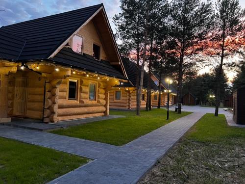 a log cabin with lights on the side of it at Ośrodek u Polaka-domek góralski in Radkowice
