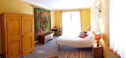 1 dormitorio con cama y ventana grande en Le Renard d'Introd, en Introd