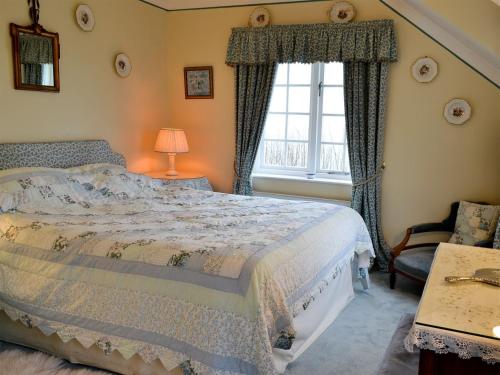 a bedroom with a bed and a window at White Rose Cottage in Robin Hood's Bay